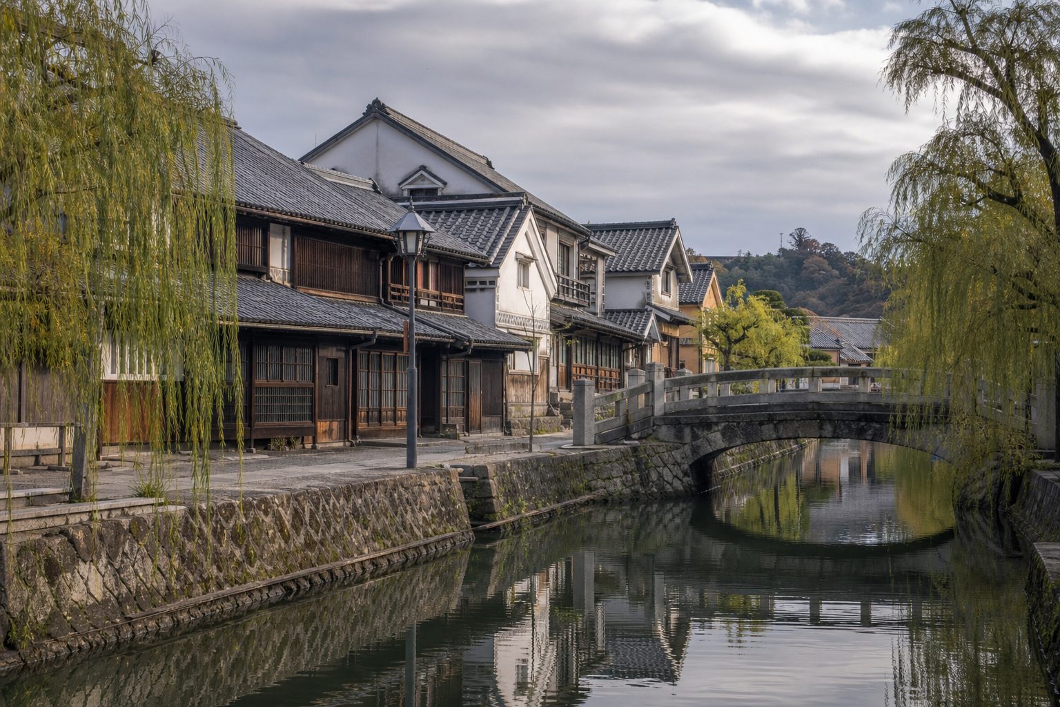 Traditional wooden houses along a calm canal in a quiet Japanese city